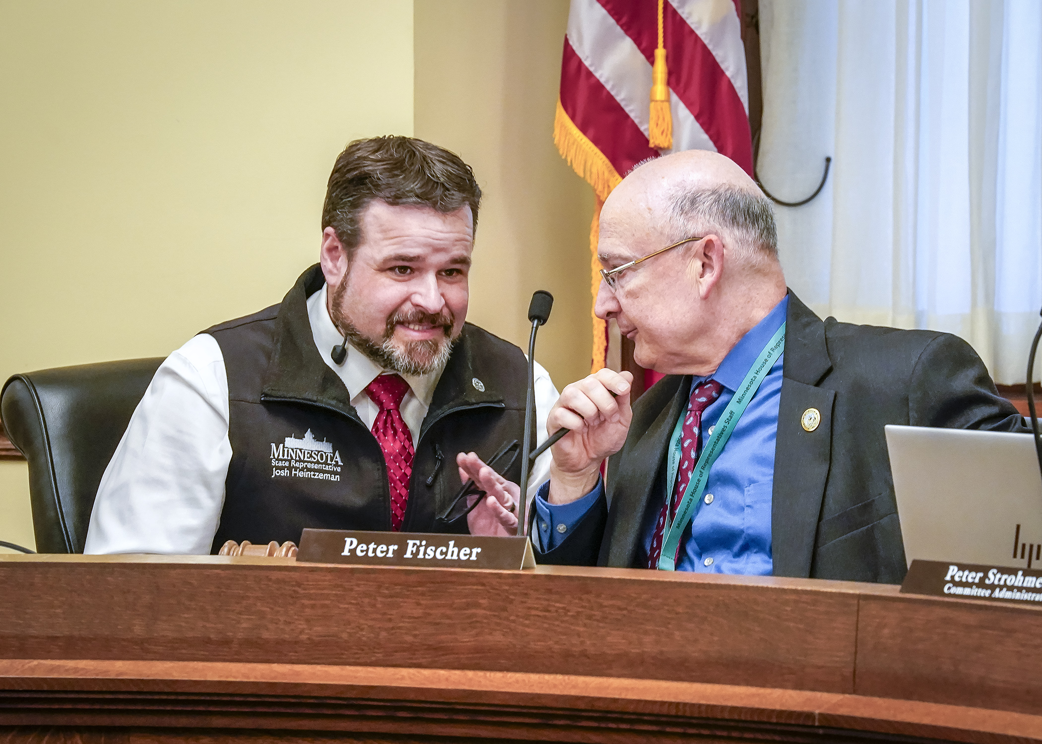 Rep. Josh Heintzeman and Rep. Peter Fischer, co-chairs of the House Environment and Natural Resources Finance and Policy Committee, confer prior to the start of their April 16 hearing. (Photo by Andrew VonBank)
